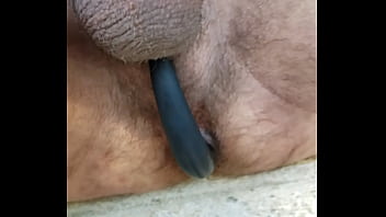 Sitting on front steps at home, flashing the world and showing one of my butt plug/ cock rings that I love to wear.